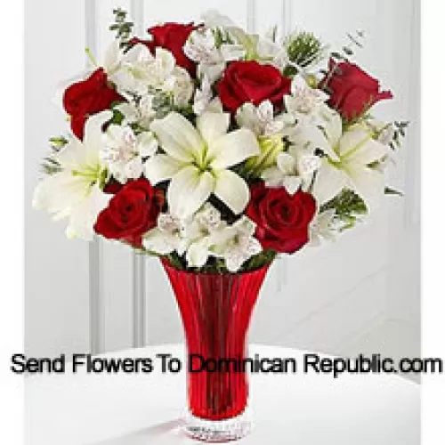 This Bouquet is a gorgeous expression of yuletide joy and elegance. Red roses pop against a background of white Asiatic lilies and Peruvian lilies lovingly arranged in a red designer glass vase to create a bouquet of seasonal celebration. (Please Note That We Reserve The Right To Substitute Any Product With A Suitable Product Of Equal Value In Case Of Non-Availability Of A Certain Product)