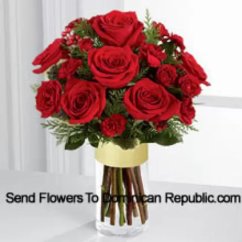 Send them the warmth and heartfelt sentiments expressed throughout the holiday season. Rich red roses and spray roses are offset by burgundy mini carnations, variegated holly stems and assorted holiday greens, beautifully arranged in a clear glass gold banded vase to bring your special recipient a merry moment they will treasure throughout the Christmas season. (Please Note That We Reserve The Right To Substitute Any Product With A Suitable Product Of Equal Value In Case Of Non-Availability Of A Certain Product)